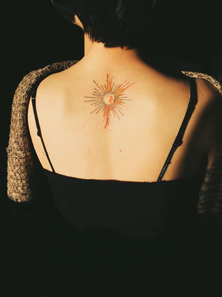sun tattoo on back