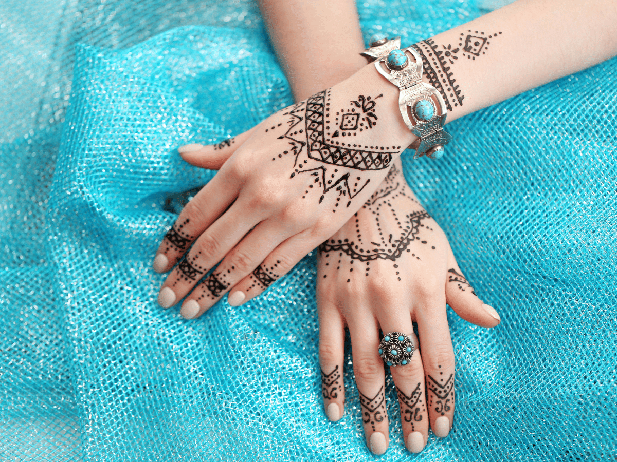 white person with henna on hands