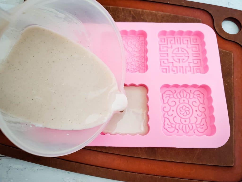 pouring soap into a soap mold 