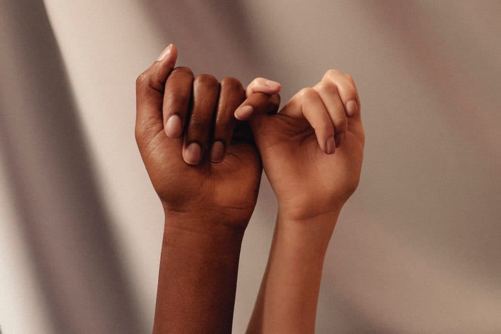 two hands, women friendship and support.