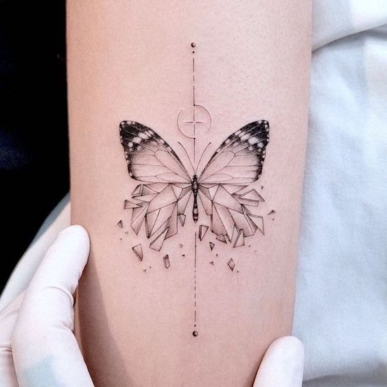 broken butterfly tattoo with shattering glass wings