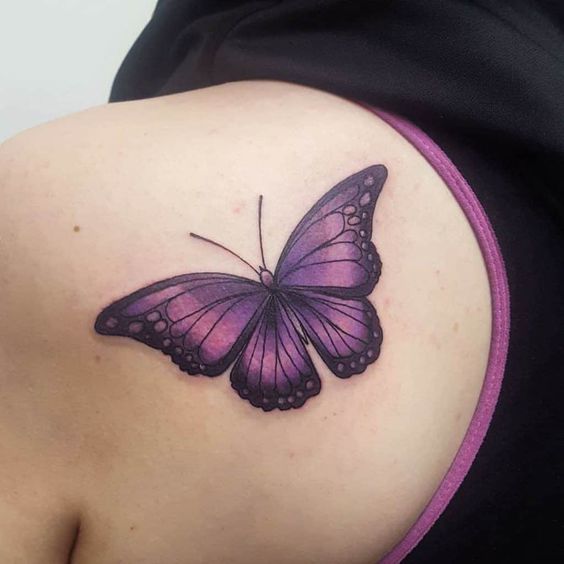 dark purple butterfly tattoo on shoulder