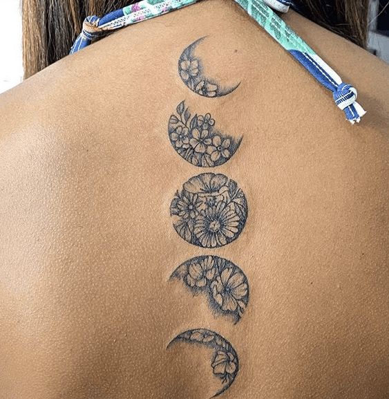 floral moon phases back tattoo
