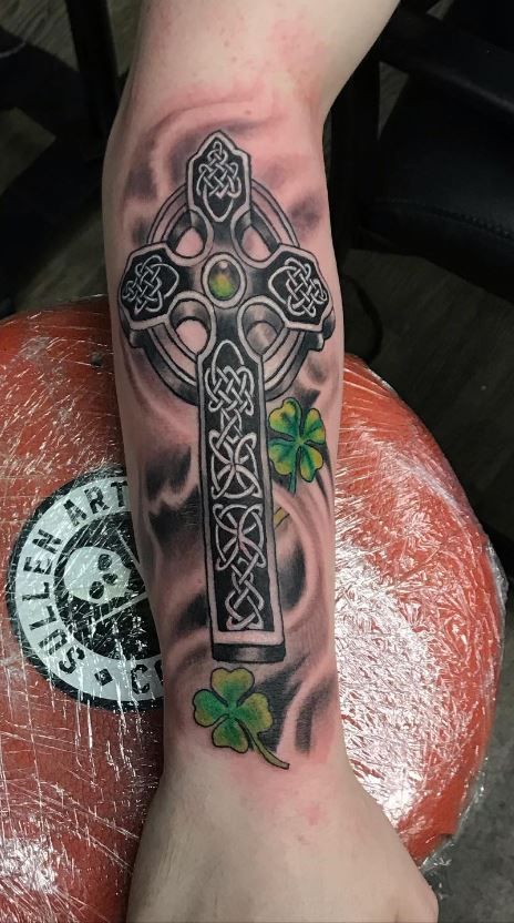 Irish celtic cross tattoo design with green emerald