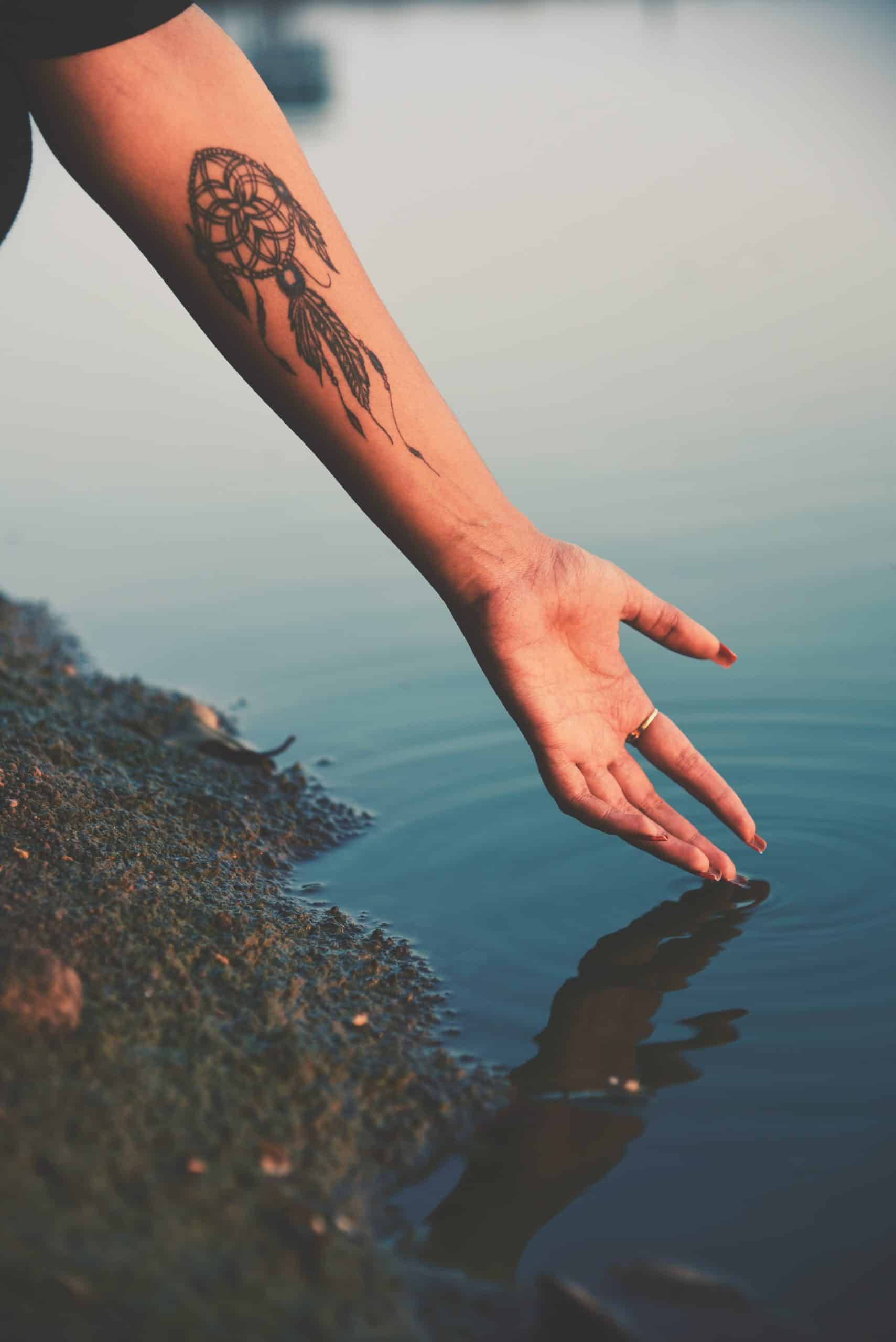 dream catcher arm tattoo 