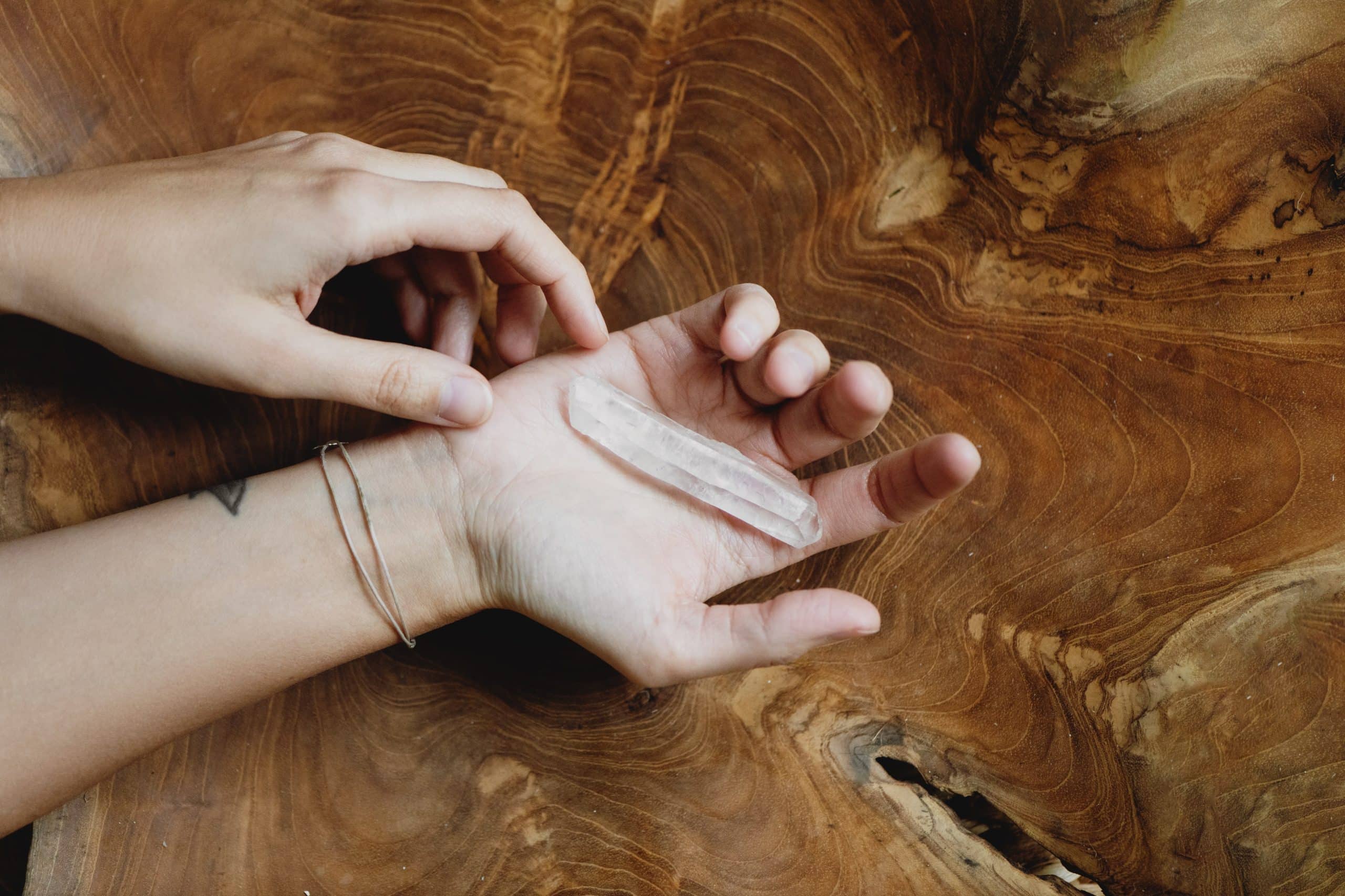 hand holding crystal wand 