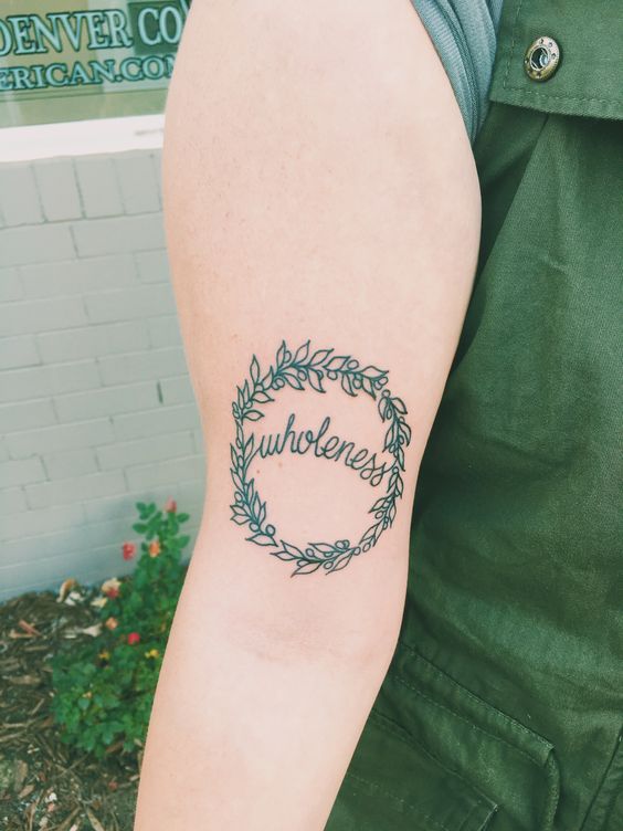 olive wreath tattoo with the word wholeness