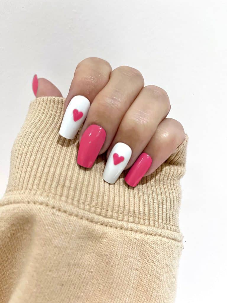 barbie inspired pink and white nails with hearts