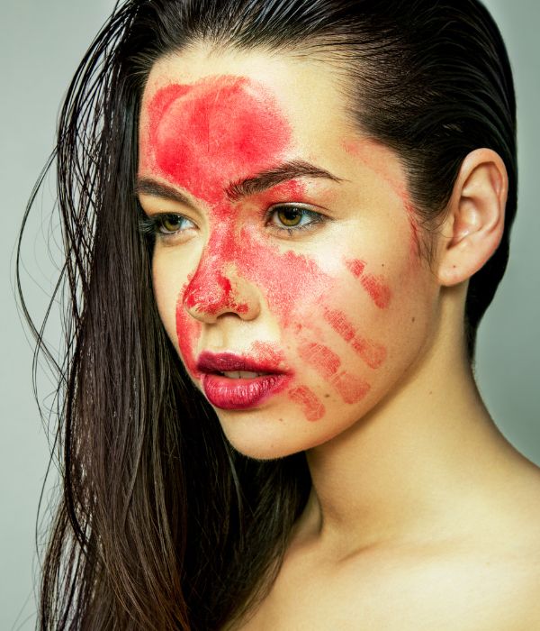 red hand print paint on face, artwork against violence