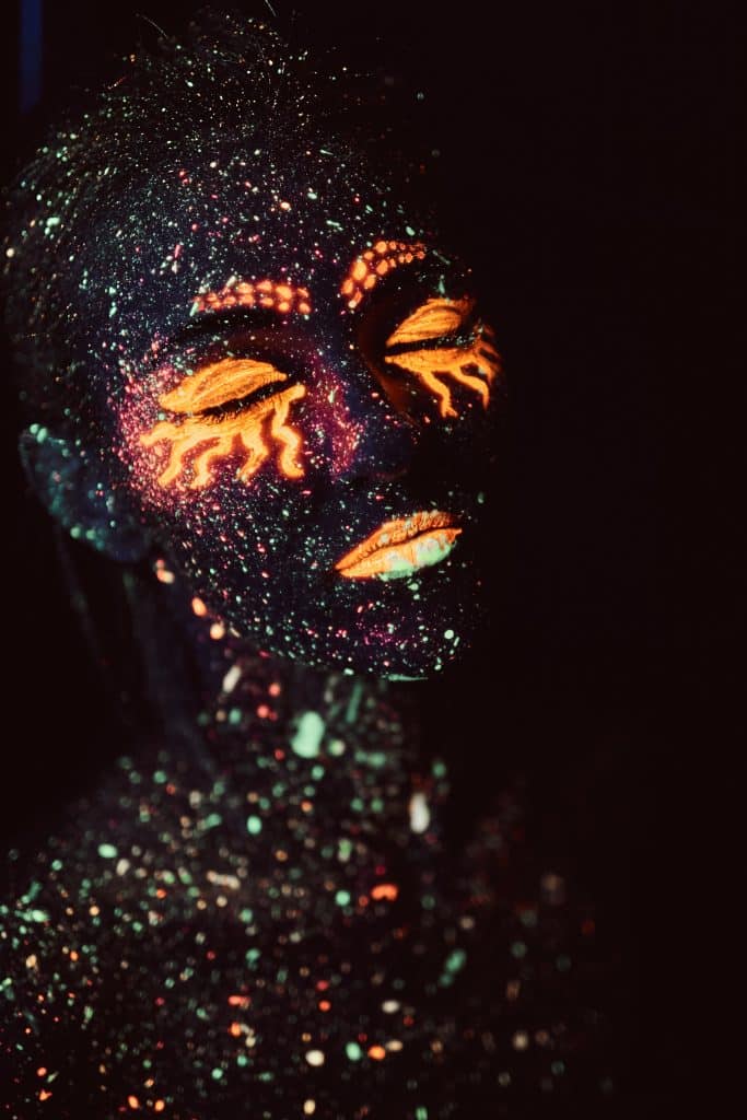 neon body paint designs for girls, orange neon face paint sun design