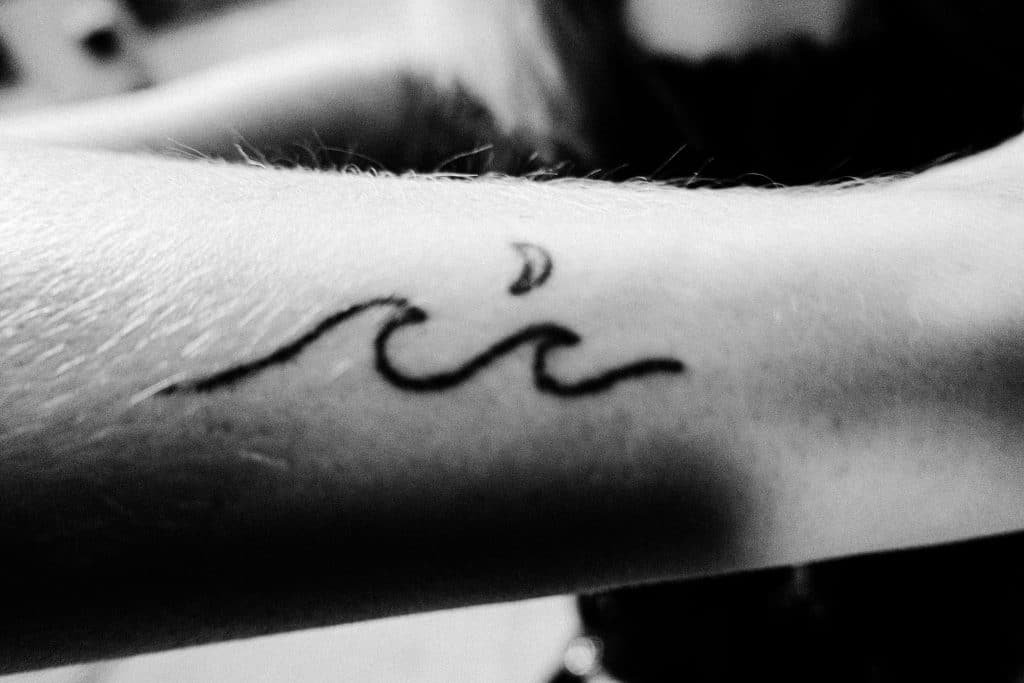 line art minimal shark wave tattoo 
