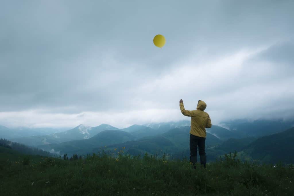 releasing a balloon symbol of letting go 