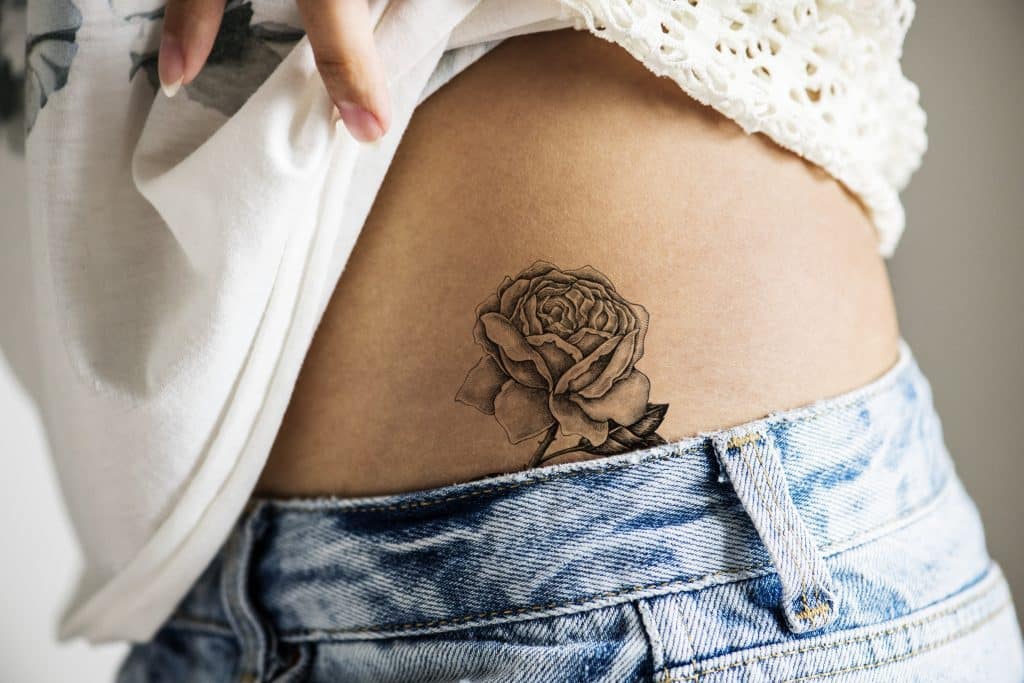 rose tattoo on hip black ink