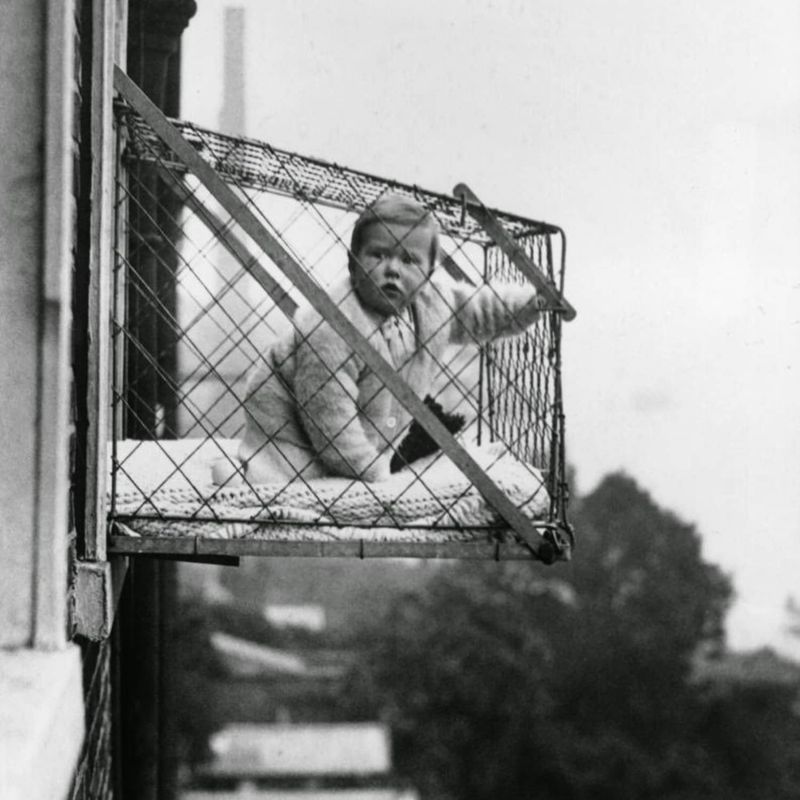 Baby Cages Attached to Apartment Windows
