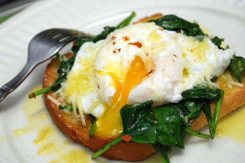 Poached Egg Over Wilted Greens and Whole Grain Toast