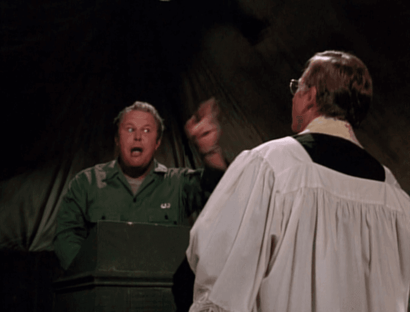Ned Beatty as a Chaplain