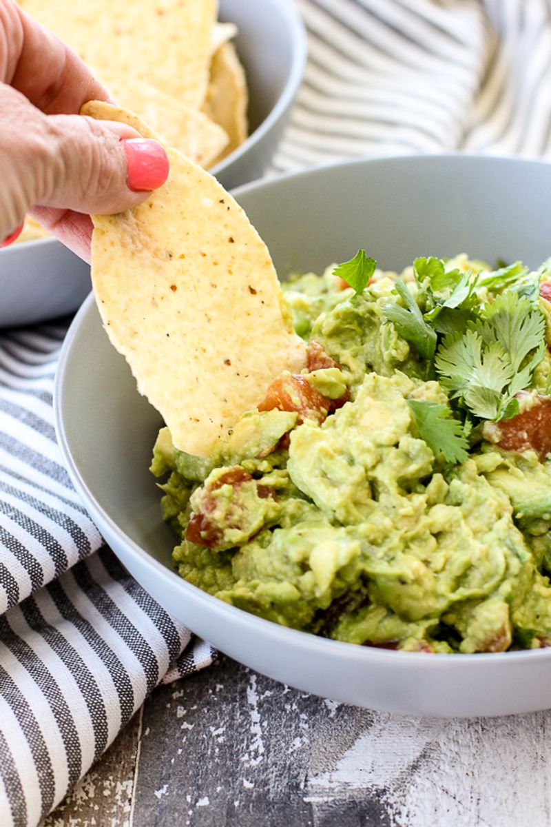 Guacamole Scooped With a Chip While Still in the Bowl