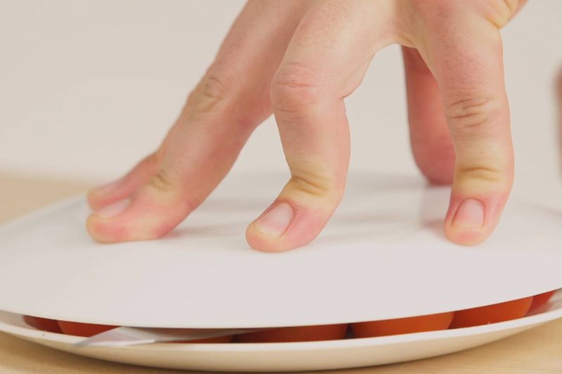 Cutting Cherry Tomatoes Between Two Plates